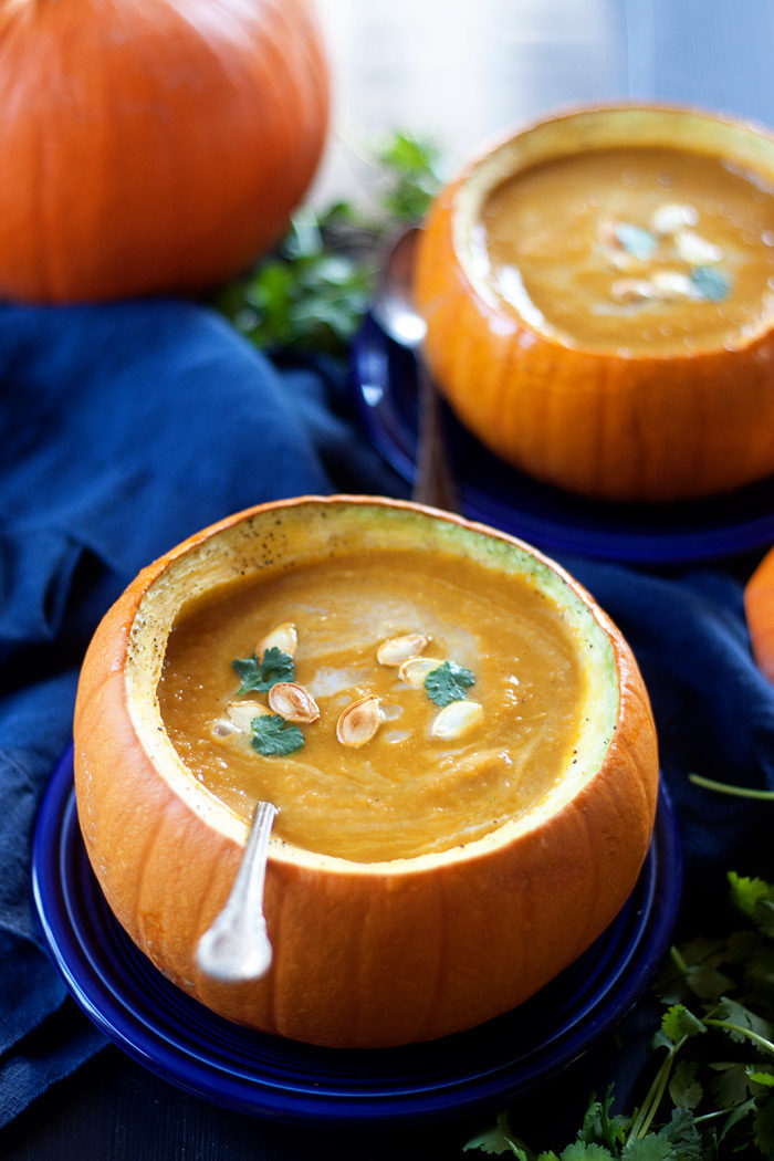 Pumpkin Curry Soup recipe - Pumpkin puree, apples, onions, and warm, earthy spices are blended together to create a pot of creamy, delicious pumpkin love! This one is made with pumpkin puree, so you can enjoy it any time of year - not just fall. Vegetarian with vegan option. 