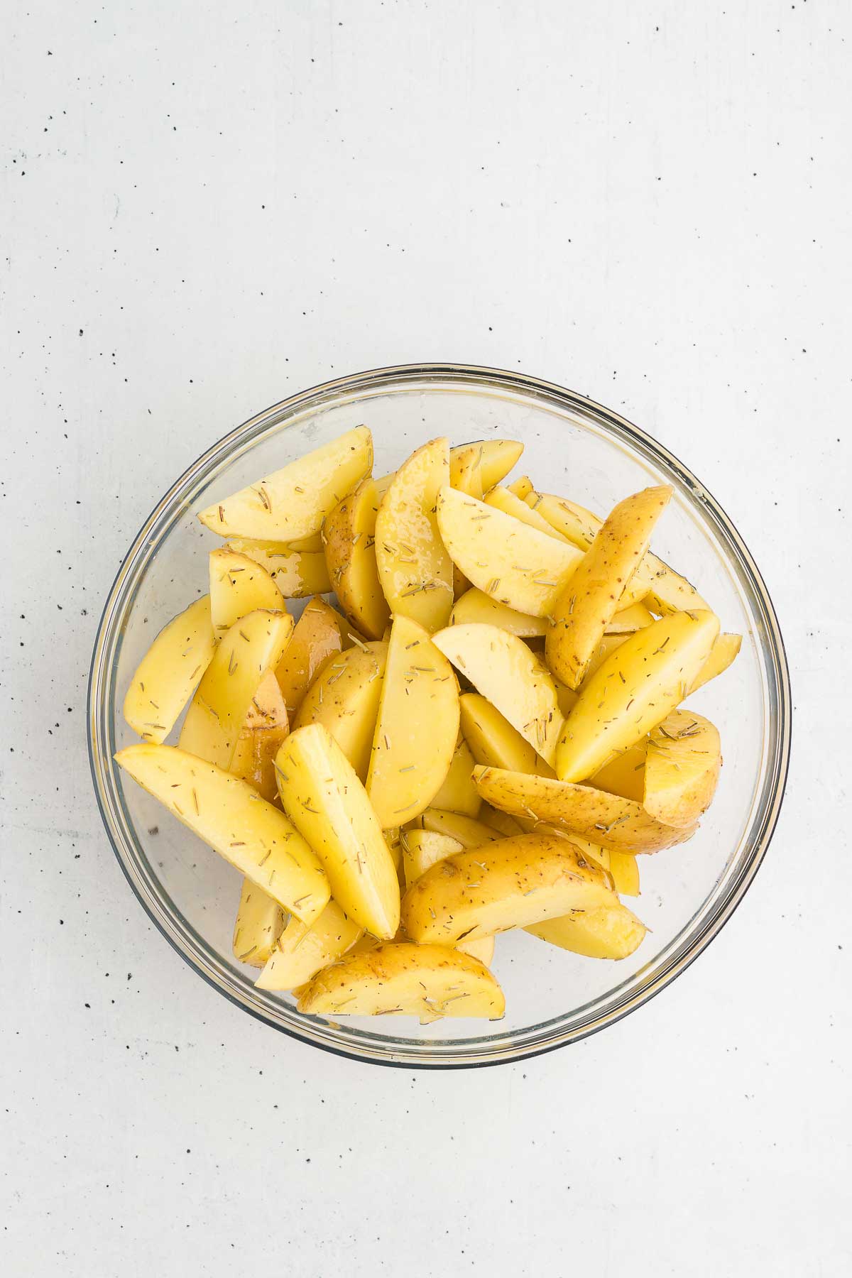 Rosemary Roasted Potatoes - raw potatoes tossed in oil, salt, and rosemary