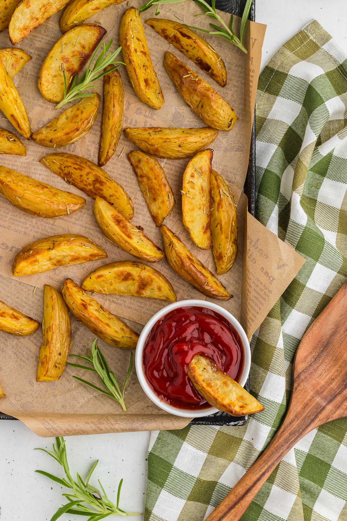 Rosemary Roasted Potatoes with ketchup and a green and white gingham napkin