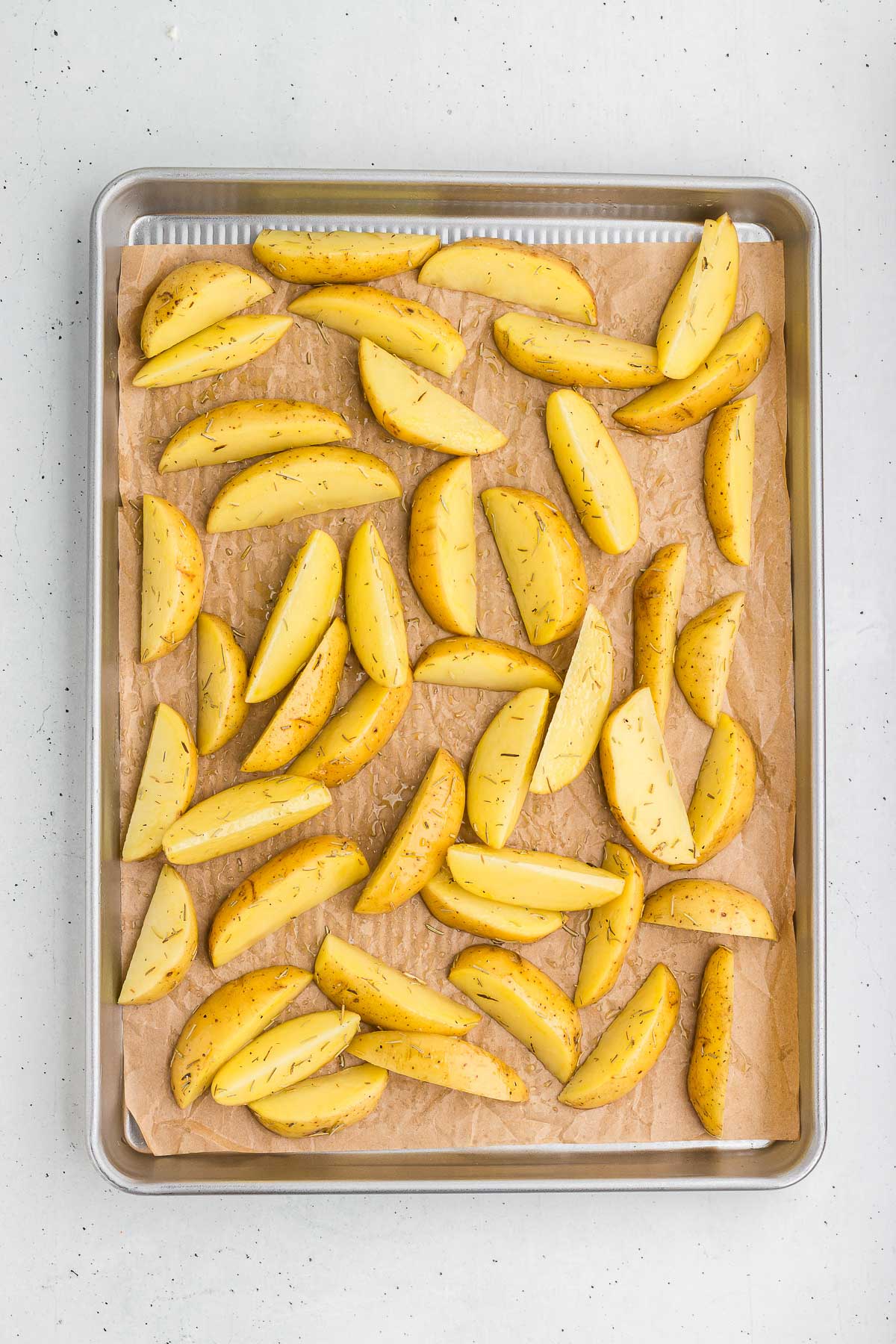 Rosemary Roasted Potatoes on a pan, ready to roast