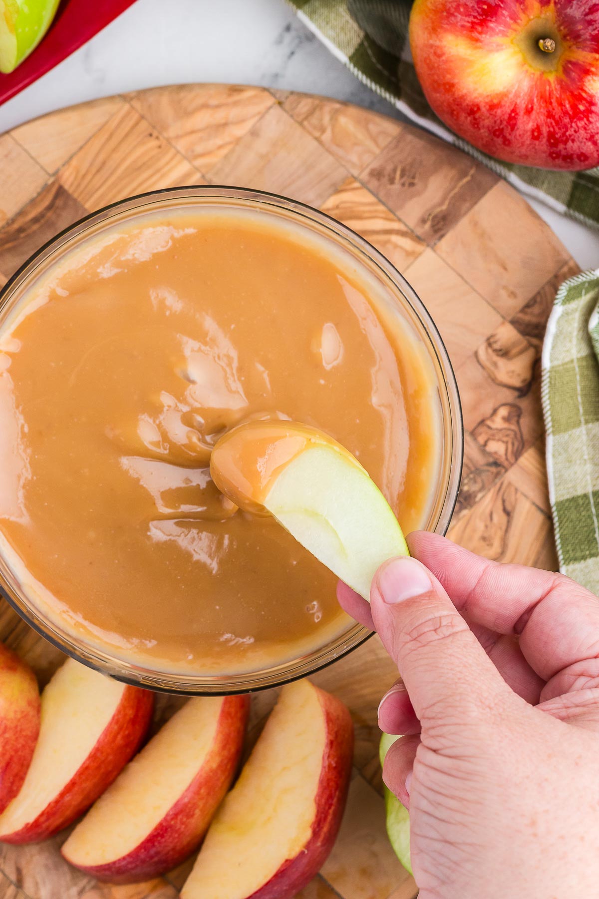 top view of an apple dipping into caramel apple dip