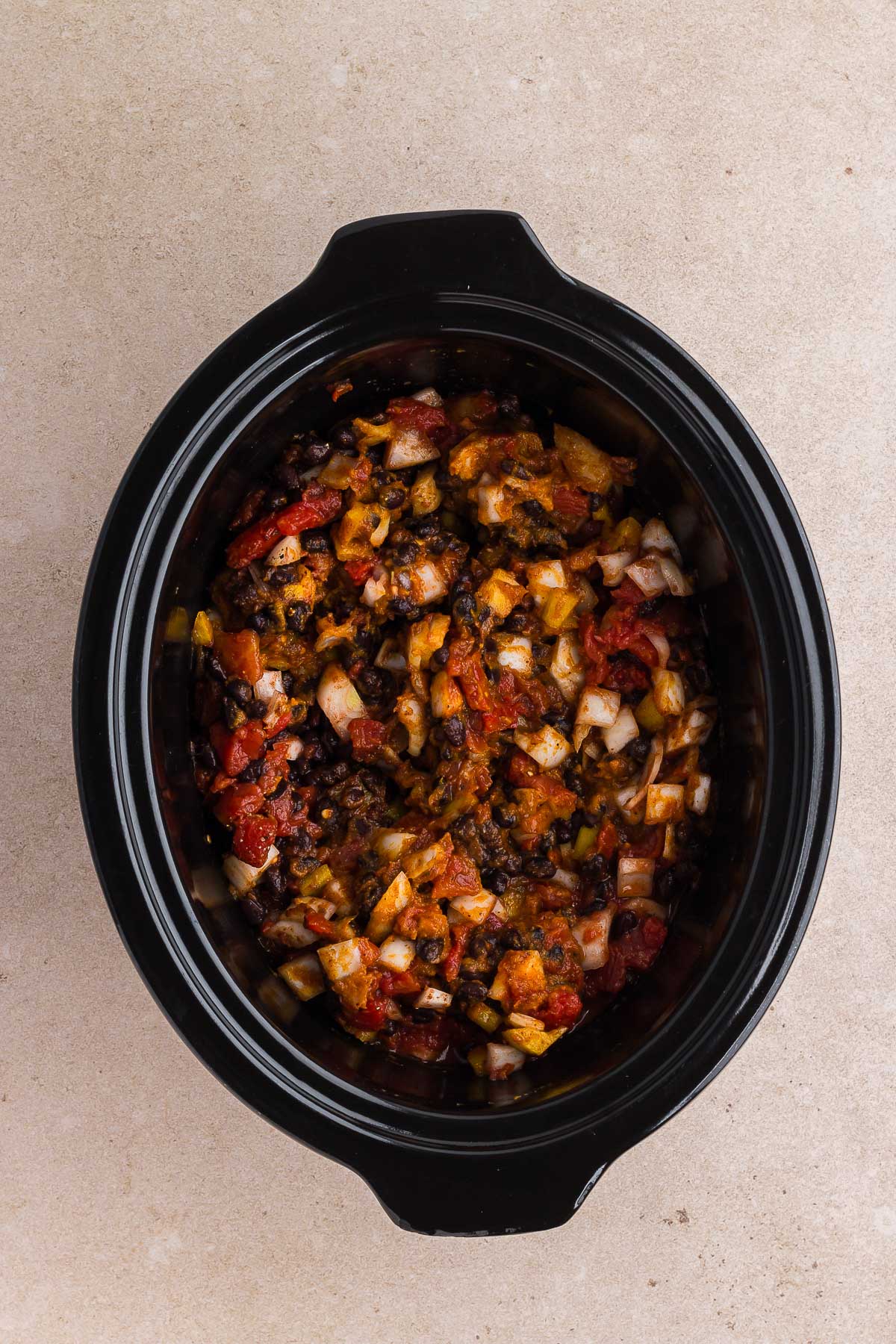 stir together the ingredients for pumpkin chili