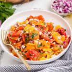 Roasted Pepper Salad in a white dish with a gold fork