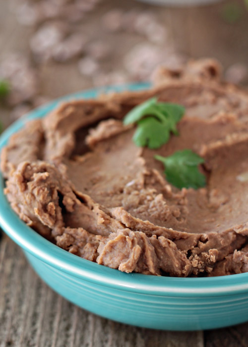 Easy Crock Pot Refried Beans (no lard!) - Creamy refried beans from scratch, right in your Crock Pot! With a simple list of ingredients, these vegetarian and vegan refried beans are a cinch to make.