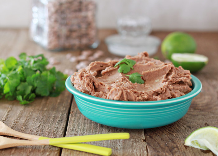 Easy Crock Pot Refried Beans (no lard!) - Creamy refried beans from scratch, right in your Crock Pot! With a simple list of ingredients, these vegetarian and vegan refried beans are a cinch to make.