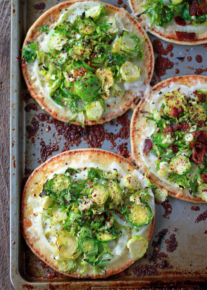 Easy Brussels Sprouts Pita Pizza recipe - Assemble these delectable little pizzas in under 10 minutes. Vegetarian; just add bacon for the meat-eaters! 