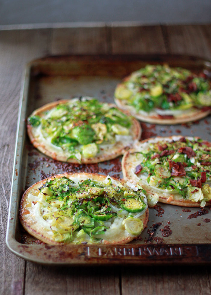 Easy Brussels Sprouts Pita Pizza recipe - Assemble these delectable little pizzas in under 10 minutes. Vegetarian; just add bacon for the meat-eaters! 
