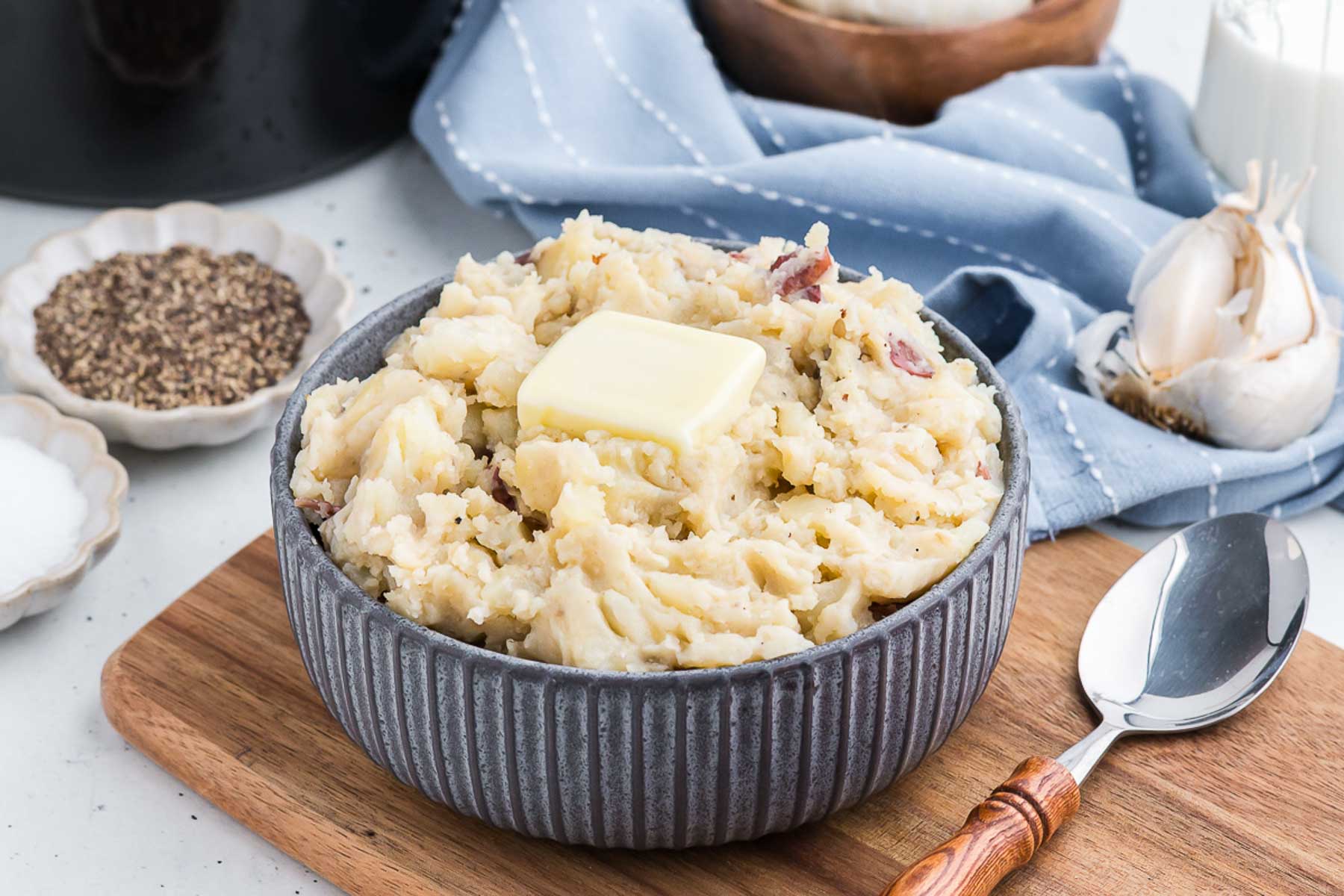 blue bowl full of crock pot garlic mashed potatoes