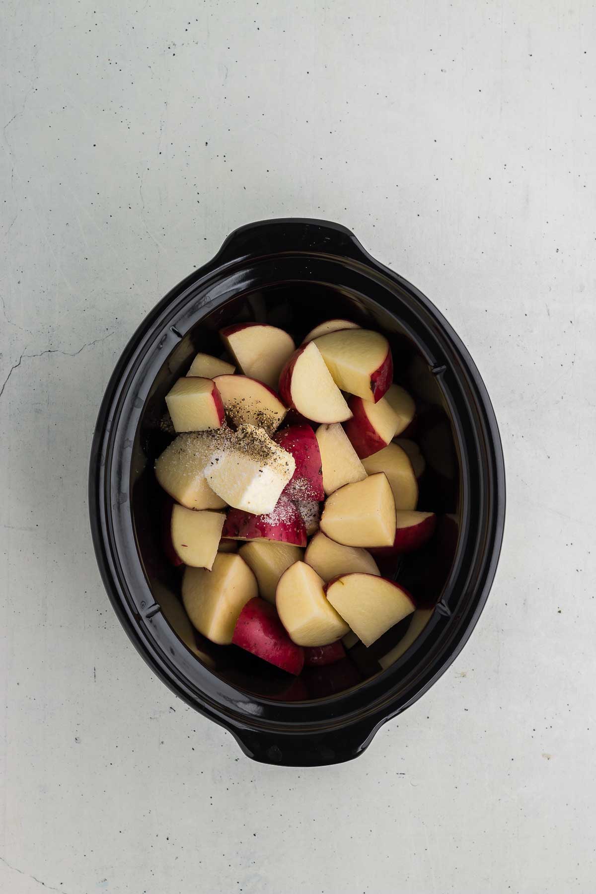 Crock Pot Mashed Red Potatoes ingredients in the slow cooker