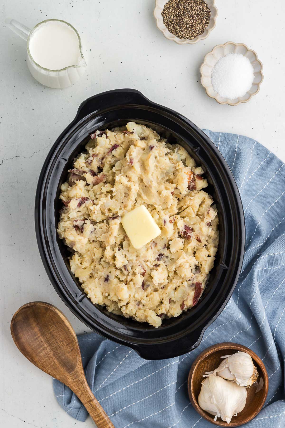 Crock Pot Mashed Red Potatoes with salt and pepper in the background