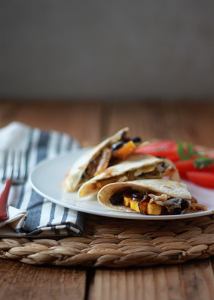 Smoky Delicata Squash & Black Bean Baked Quesadillas - Spicy seared delicata squash, blackened onions, black beans, and pepper jack, tucked inside a tortilla and baked until melty and golden. Serve with a little pico de gallo or fresh tomato slices and dinner's made!