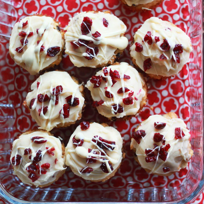 Cranberry Bliss Muffins - Inspired by the famous Starbucks bars, these cream-cheese frosted muffins are studded with cranberries and white chocolate. The perfect breakfast treat for the holidays!