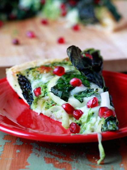 Kale & Pomegranate Pizza with Creamy Pesto Sauce recipe - Two doses of kale - both in the creamy, garlicky pesto and piled on top - make this pizza a green powerhouse. In the most delicious way - promise. Top with ruby-red pomegranate arils for color and a little irresistible sweet and salty contrast.