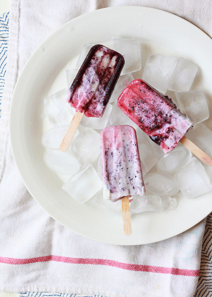 Coconut Berry Firecracker Ice Pops - Only 5 ingredients go into these creamy homemade dairy-free popsicles made with coconut milk, strawberries, and blueberries. 