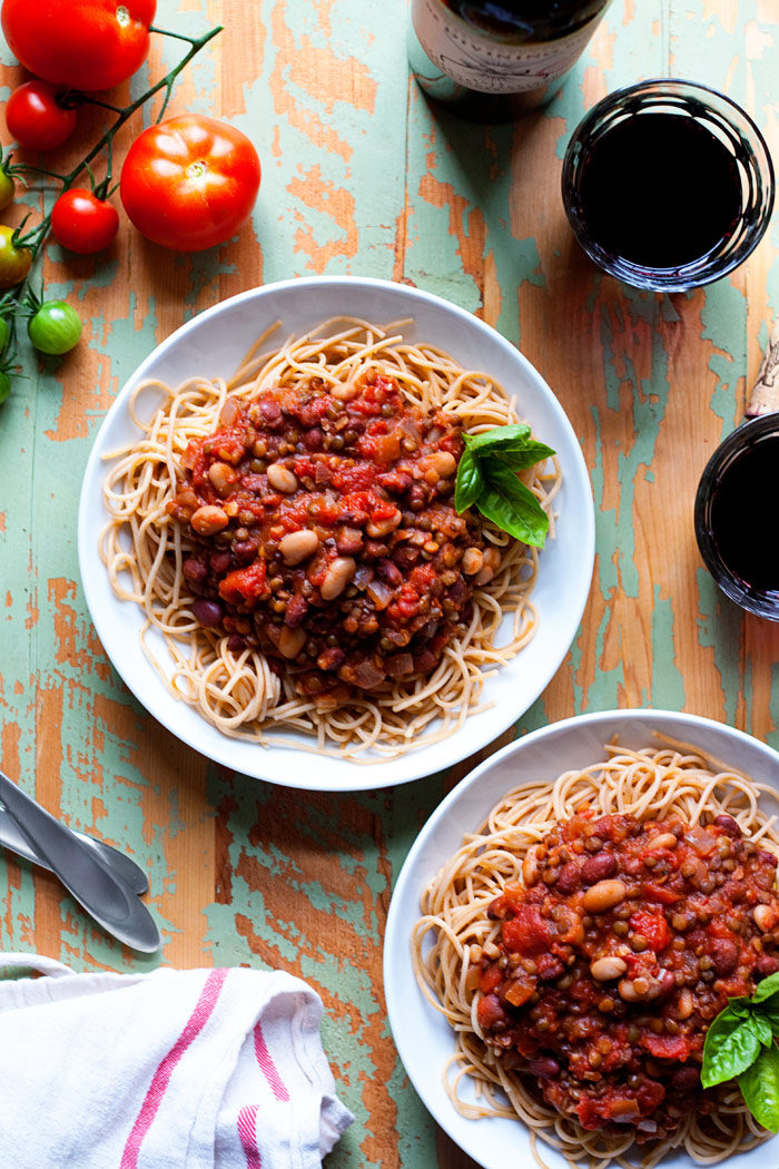 Hearty Bean & Lentil Vegan Bolognese Recipe - Tomatoes and garlic simmered together with lentils and beans for a thick, hearty, and protein-rich take on classic marinara. Vegetarian/vegan.