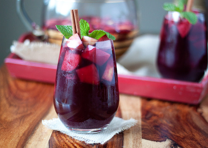 Juicy Red Apple Sangria recipe - A lush red sangria with apples, spices, brandy, and more. We love this sangria for the holidays.