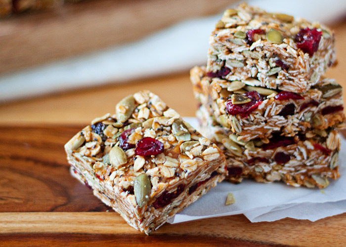 No-Bake Peanut Butter Granola Bars with Dried Cranberries & Pepitas - These refrigerator granola bars take mere minutes to assemble. Our favorite homemade grab-and-go snack! Vegan, GF. 