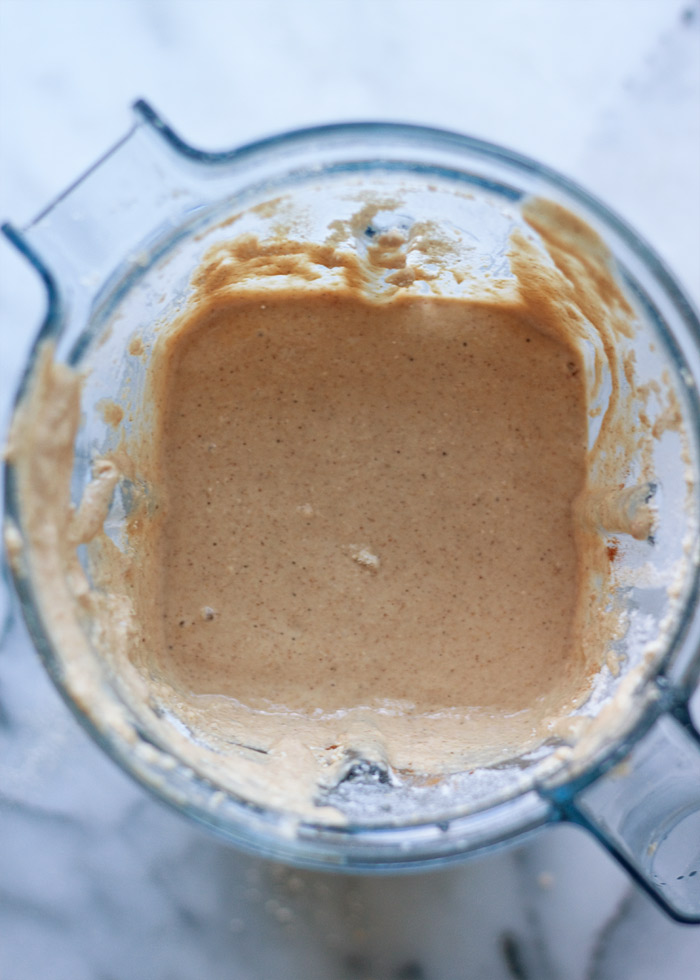 Banana oatmeal pancake batter in the pitcher of a high-speed blender, ready to pour onto a griddle and cook. 