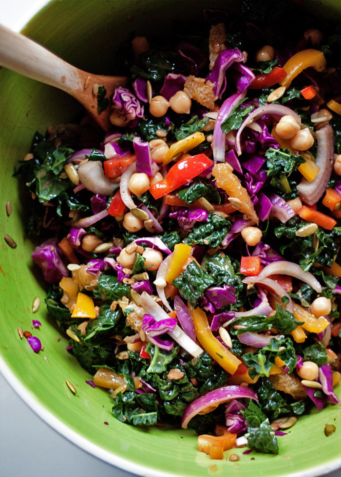 Hippie Chopped Salad recipe - Nearly every color of the rainbow is represented in this salad with kale, crunchy bell peppers, juicy oranges, and more. Chickpeas, sunflower seeds, and pepitas add protein and crunch! All that and oil-free too. 