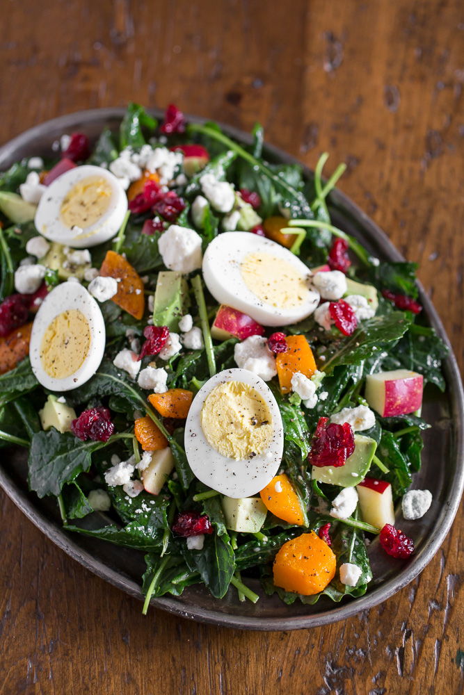 Leafy baby kale salad with cranberries, apples, roasted butternut squash, and eggs