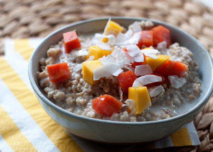 Uber-creamy and utterly flavorful oats topped generously with mango, papaya, and coconut. Like a taste of the tropics, any time of year! Vegan and gluten-free.
