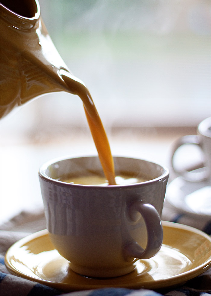 Pouring golden milk into a mug