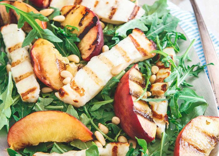 Grilled Halloumi & Peach Salad - Grilled halloumi, juicy peaches, and fresh arugula in this Grilled Halloumi & Peach Salad means you get a salty, sweet and zesty element all in one light bite. Vegetarian. 