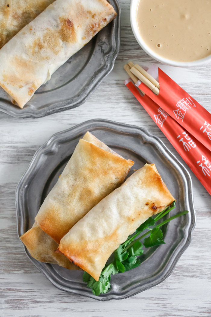 Crispy Baked Veggie Egg Rolls recipe - These veggie-packed egg rolls crisp up perfectly in the oven - no deep frying necessary. Just add chicken for the omnivores - easily made vegan too!