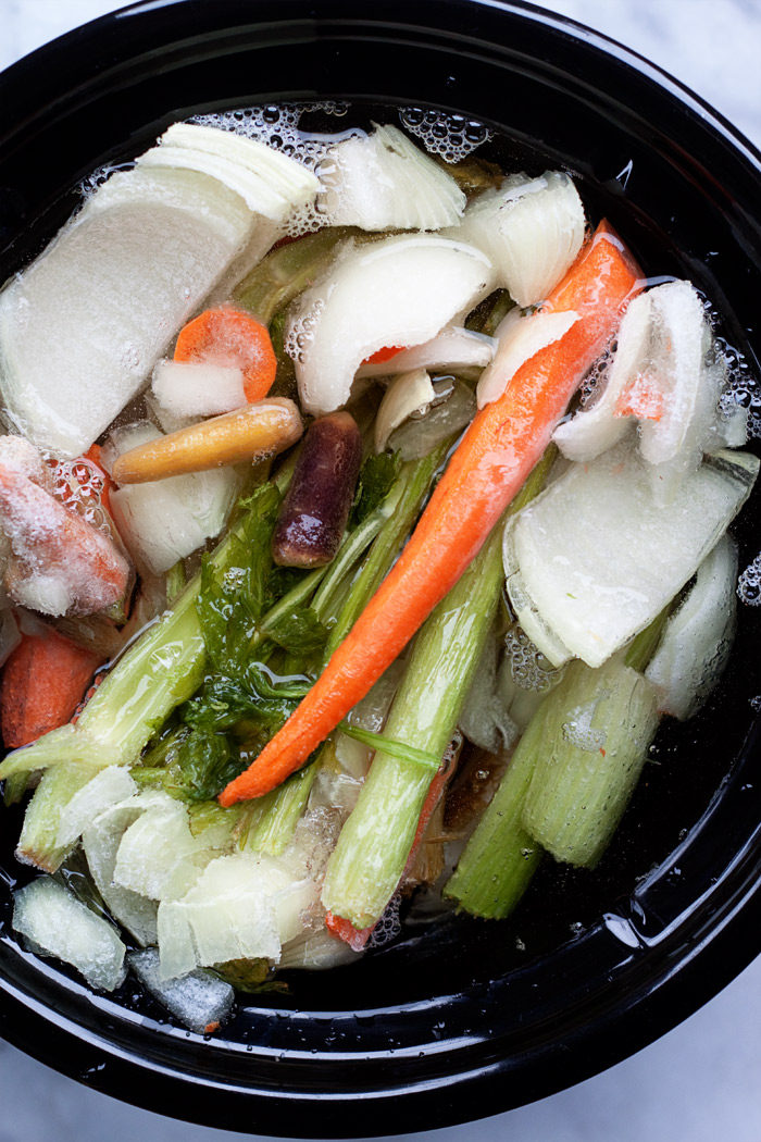 How to Make Vegetable Broth in the Slow Cooker - Grab your veggie scraps and your Crock Pot and make up your very own batch of golden-delicious veggie broth! It's easy.