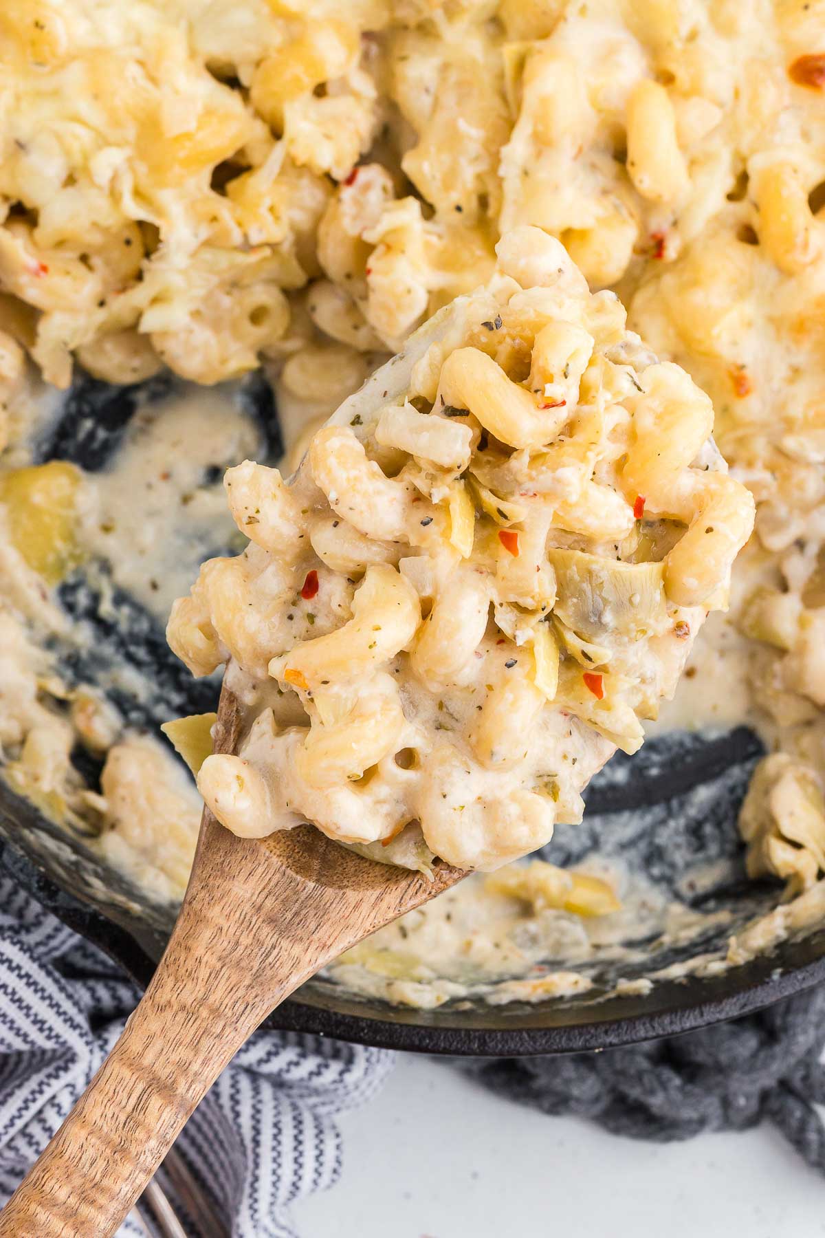a spoonful of creamy artichoke baked pasta