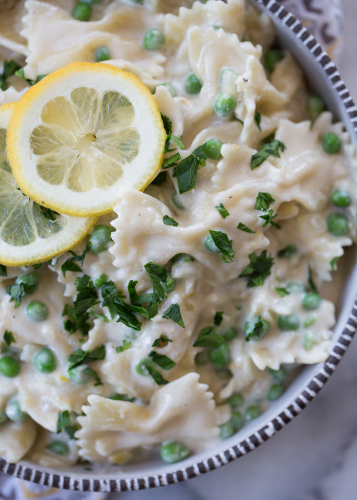 Vegan Creamy Lemon Pasta with Peas - Luxuriously creamy pasta with a lemony twist and a simple list of ingredients. Love how quickly this velvety pasta comes together! Just add a bit of ham for the carnivores.