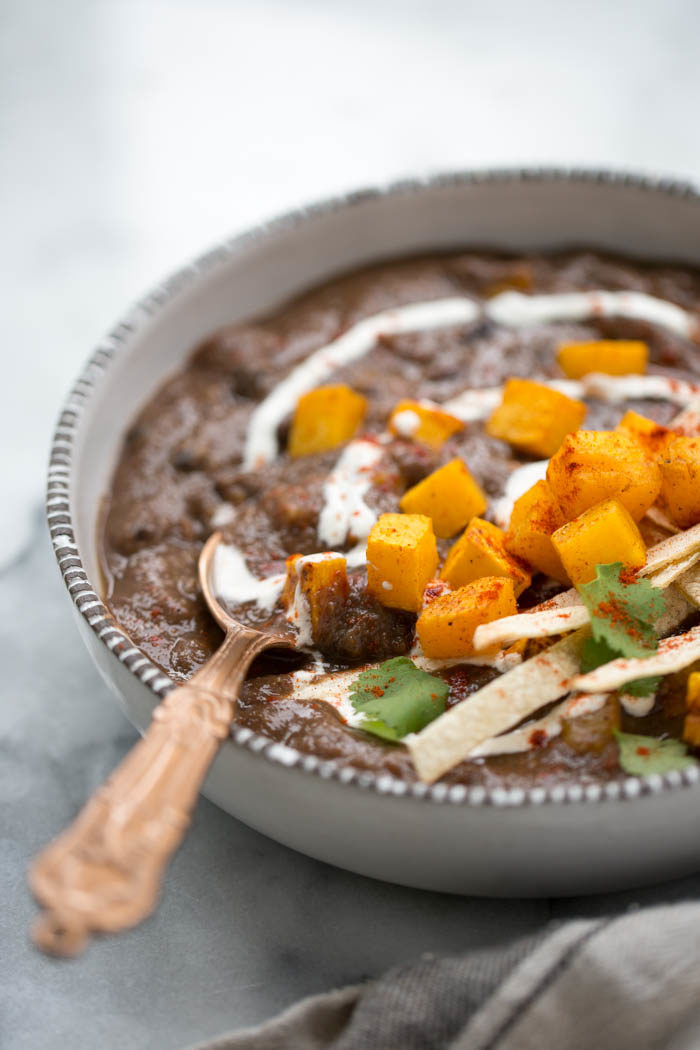 Roasted Butternut Squash Black Bean Soup is a hearty, warming soup that's perfect for chilly fall and winter evenings. Packed with protein, so easy to make, and extremely satiating. #vegansoup #veganfallsoup #easysoup