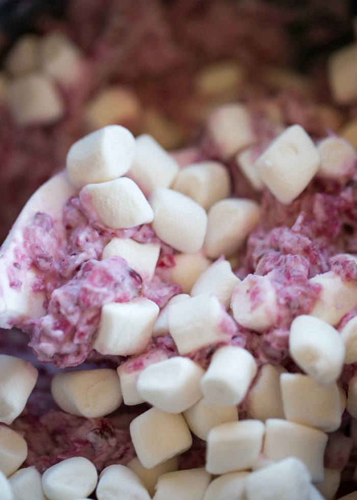 Creamy, dreamy cranberry fluff salad made vegan with coconut whipped cream and vegan-friendly mini marshmallows. Is it a salad? Is it a dessert? Does it matter? :) #veganchristmas #vegancranberrysalad #cranberrysalad