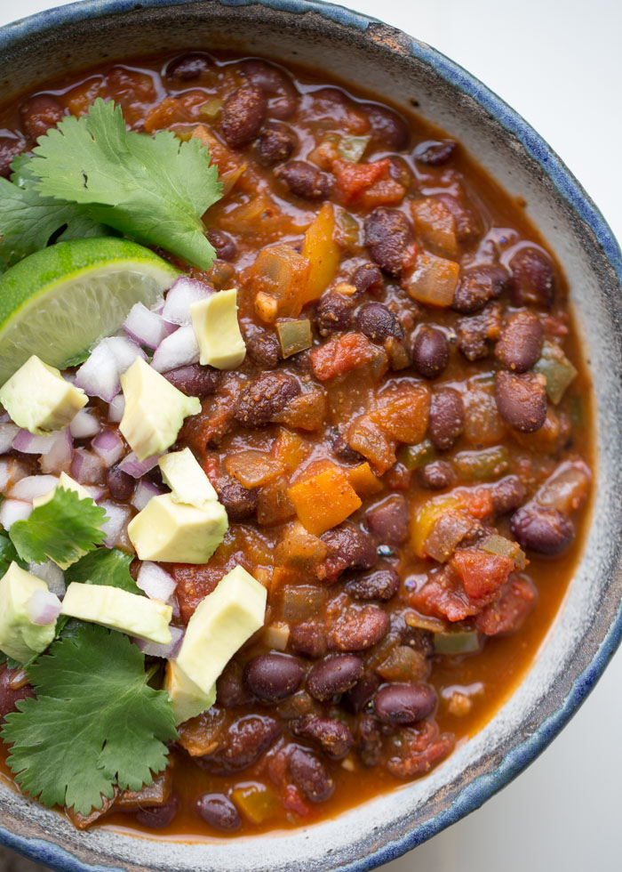 Simple Instant Pot Vegan Black Bean Chili - With less than 10 ingredients, this hearty chili comes together quickly and easily. It might be fast and simple, but thanks to the magic of pressure cooking, it tastes like it simmered all day. So, so good! #instantpotchili