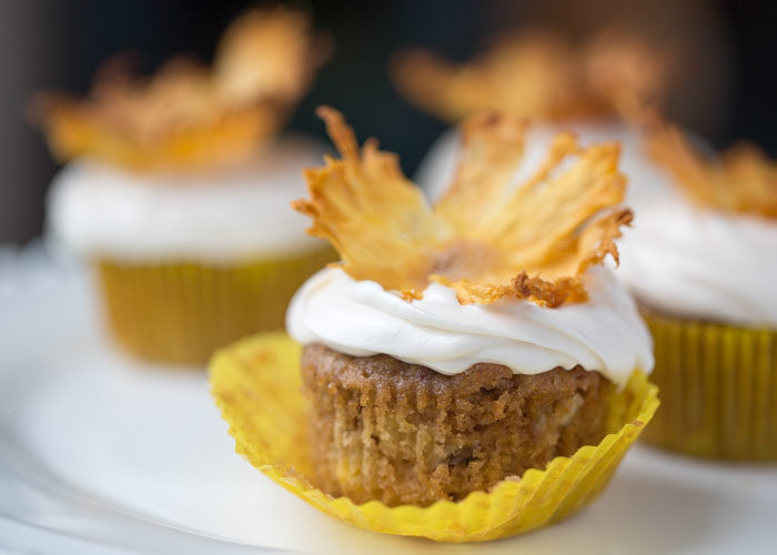 Hummingbird Cupcakes recipe - Moist and ultra-tender banana cupcakes flecked with pineapple, pecans, and coconut. Add a dollop of cream cheese frosting and crown with a dried pineapple flower for cupcakes that'll impress, guaranteed! Dairy-free option.