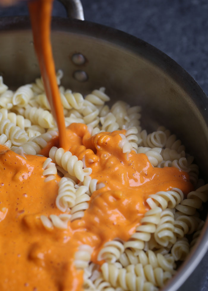 Creamy Vegan Roasted Red Pepper Pasta - Got 20 minutes? Then you've got dinner! An impossibly creamy, full-of-flavor sauce coats pasta for this awesomely easy pasta dish that'll please vegans and carnivores alike.