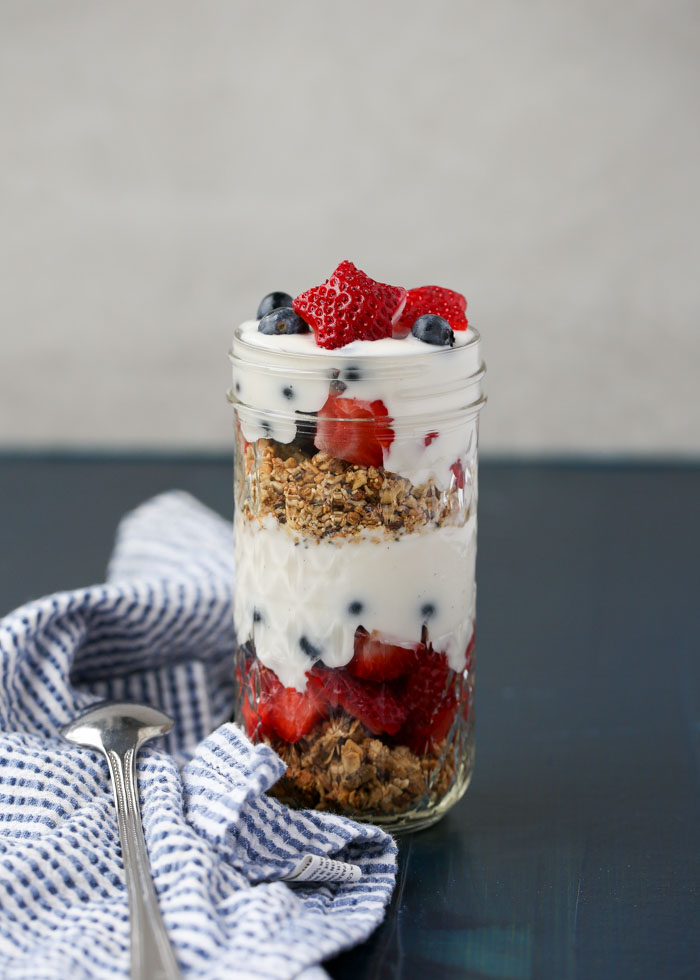 Strawberries, blueberries, granola, and yogurt (vegan if you prefer), all layered up.