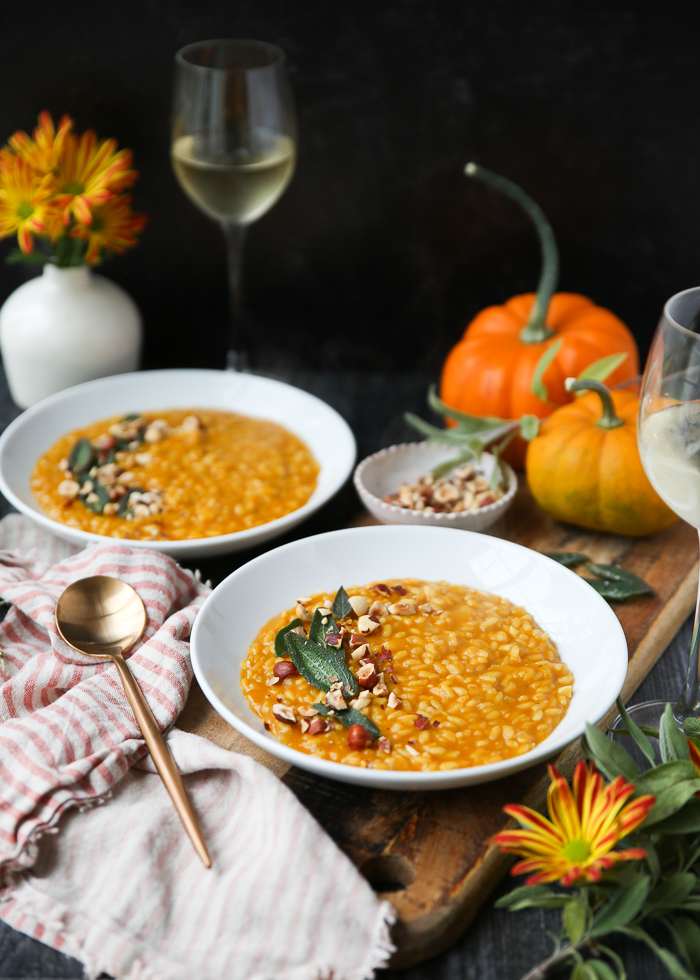 Creamy Vegan Pumpkin Risotto - A surprisingly simple autumnal risotto made with pumpkin puree and a secret ingredient for an umami boost. Plus, a toasted hazelnut and crispy fried sage leaf garnish that take it over the top! #veganrisotto #fallrisotto #veganpumpkinrisotto