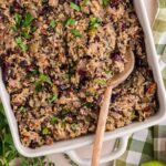 top view of Herbed Quinoa & Wild Rice Stuffing with a wooden spoon