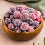wooden bowl full of sugared cranberries