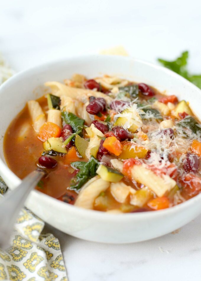 A comforting bowlful of beans, pasta, and veggies overflowing in a tomato-based broth. Please pass the shredded parm and hunks of crusty bread!