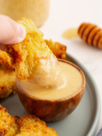 A chicken nugget dipping into honey dijon mustard dressing