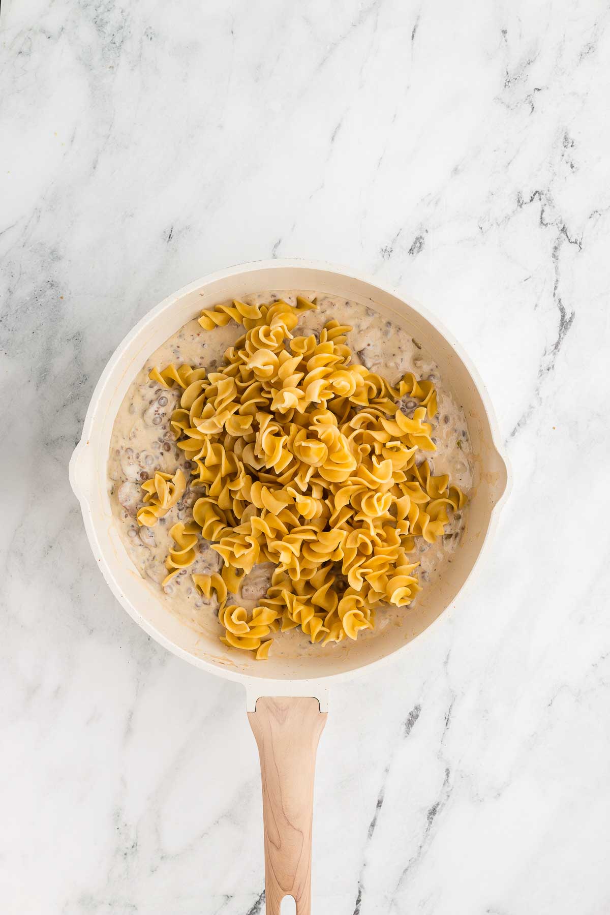 adding pasta to Mushroom Lentil Stroganoff