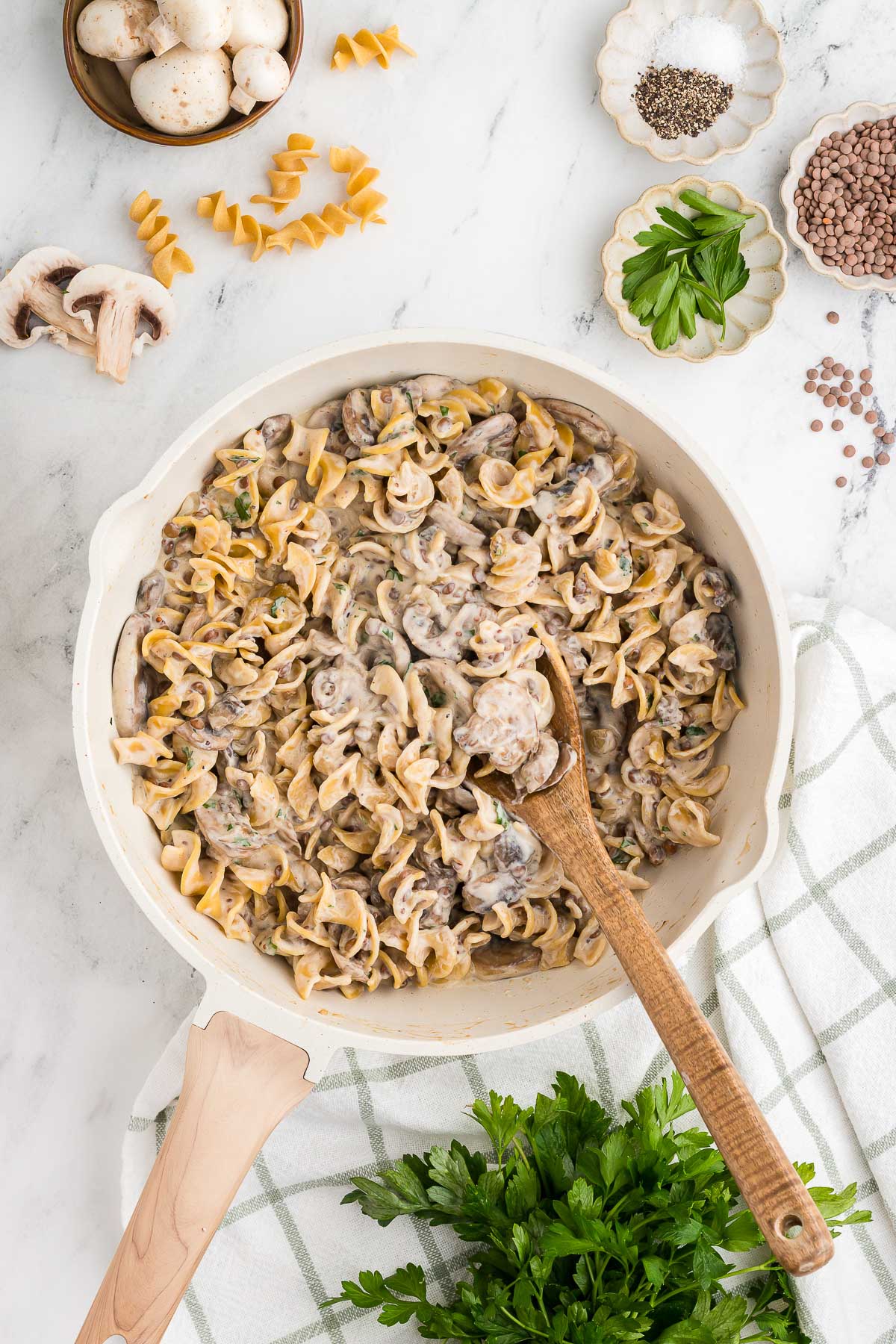 vegetarian stroganoff in a skillet with a wooden spoon