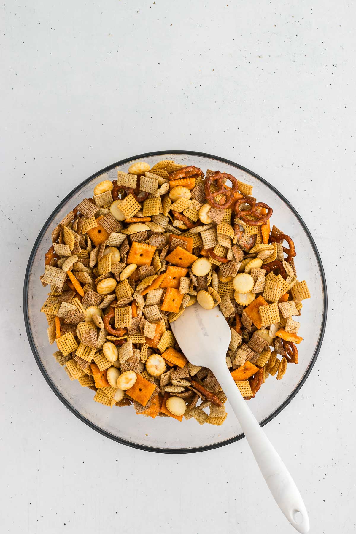 mixing the butter mixture into the Ranch Chex Mix