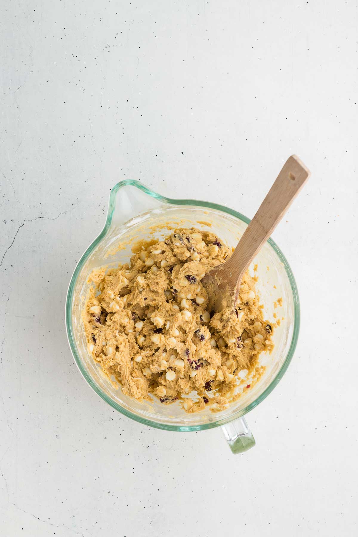 White chocolate chips and cranberries stirred into Cranberry Orange White Chocolate Chip Cookies