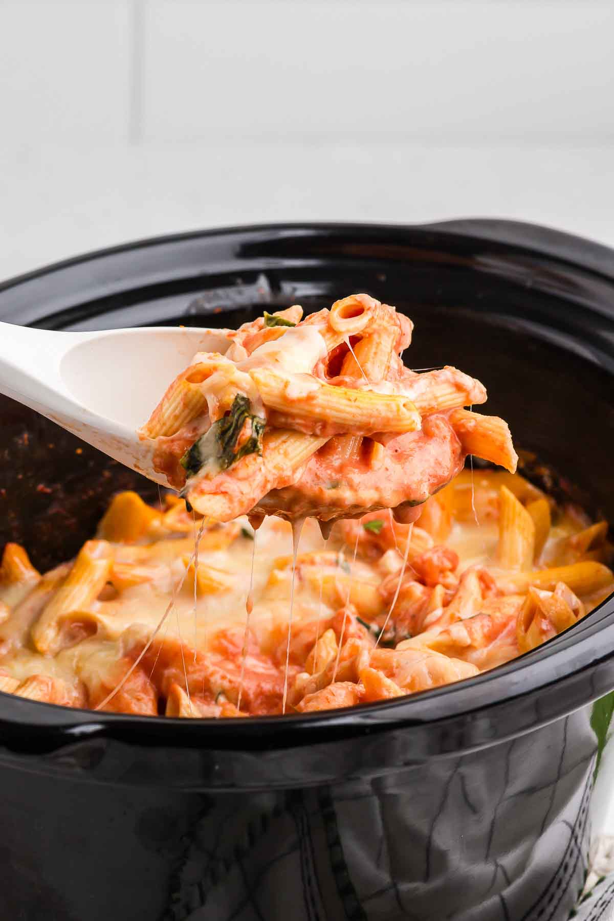 Lifting Crock Pot Baked Ziti out of the Crock Pot