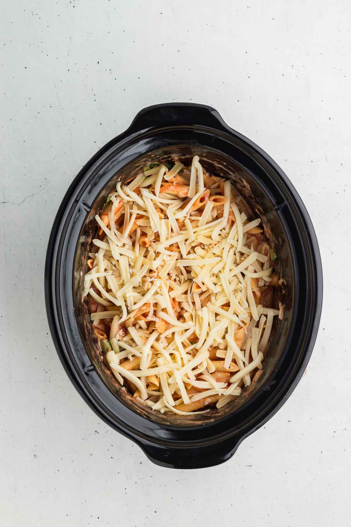 Topping Crock Pot Baked Ziti with cheese