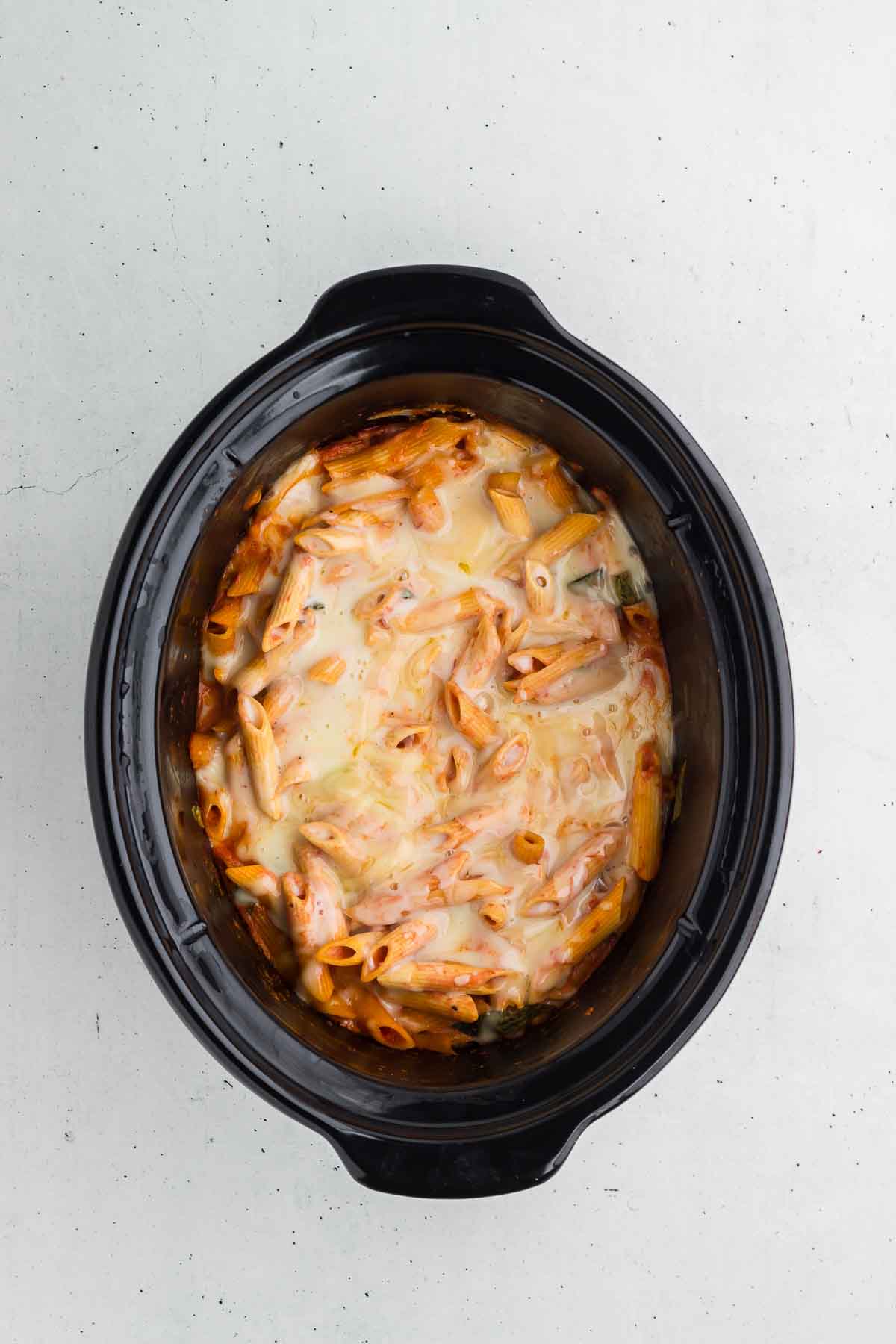 Crock Pot Baked Ziti with melted cheese on top, ready to serve