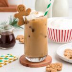 Gingerbread Iced Latte with a gingerbread cookie perched on top